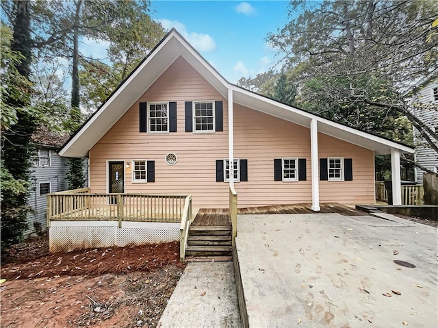 rear view of house featuring a wooden deck