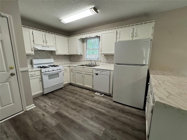 671 Peach Crossing Dr, Dallas, GA 30132 - kitchen featuring white appliances, under cabinet range hood, light countertops, white cabinets, and a textured ceiling