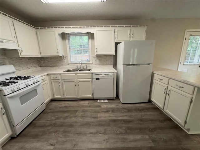 671 Peach Crossing Dr, Dallas, GA 30132 - kitchen featuring white appliances, under cabinet range hood, healthy amount of natural light, and dark wood-type flooring