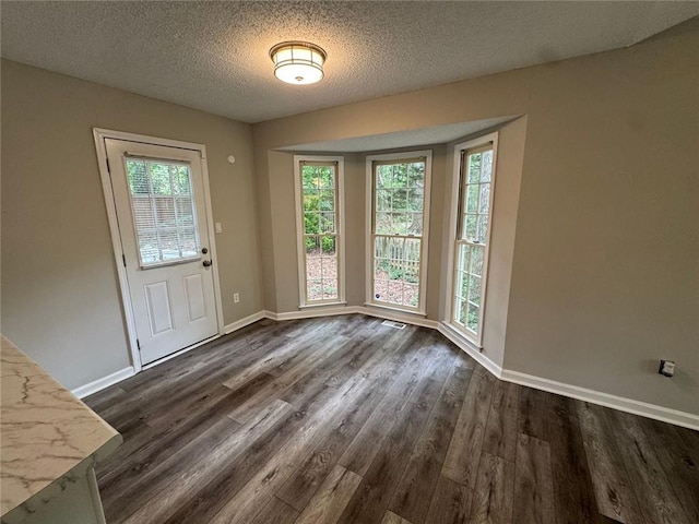 671 Peach Crossing Dr, Dallas, GA 30132 - entryway with dark wood finished floors and a textured ceiling