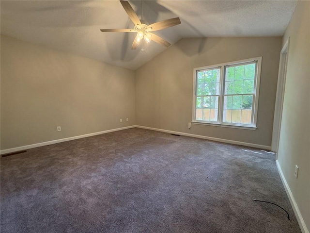 671 Peach Crossing Dr, Dallas, GA 30132 - spare room featuring a ceiling fan, lofted ceiling, dark carpet, and a textured ceiling
