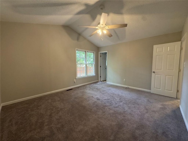 671 Peach Crossing Dr, Dallas, GA 30132 - unfurnished room featuring ceiling fan, vaulted ceiling, dark carpet, and a textured ceiling