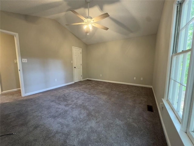 671 Peach Crossing Dr, Dallas, GA 30132 - spare room with lofted ceiling, ceiling fan, and dark carpet
