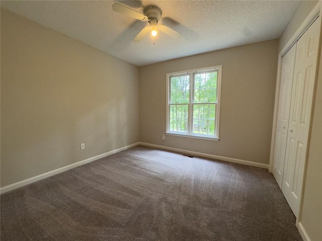 671 Peach Crossing Dr, Dallas, GA 30132 - unfurnished bedroom with a textured ceiling, a closet, carpet floors, and a ceiling fan
