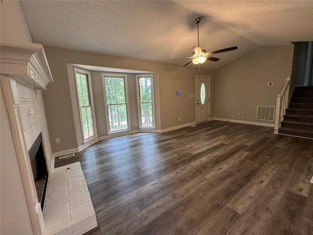 671 Peach Crossing Dr, Dallas, GA 30132 - unfurnished living room featuring stairway, a ceiling fan, a brick fireplace, dark wood finished floors, and a textured ceiling