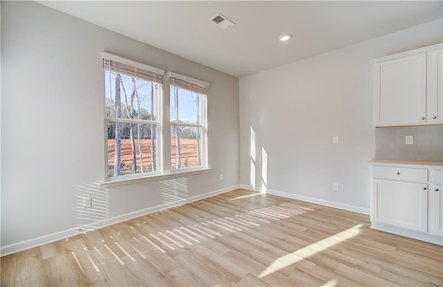 unfurnished dining area with light hardwood / wood-style floors