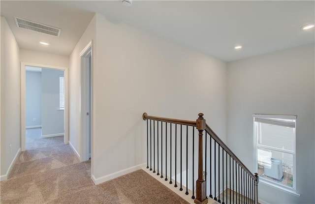 corridor with light colored carpet