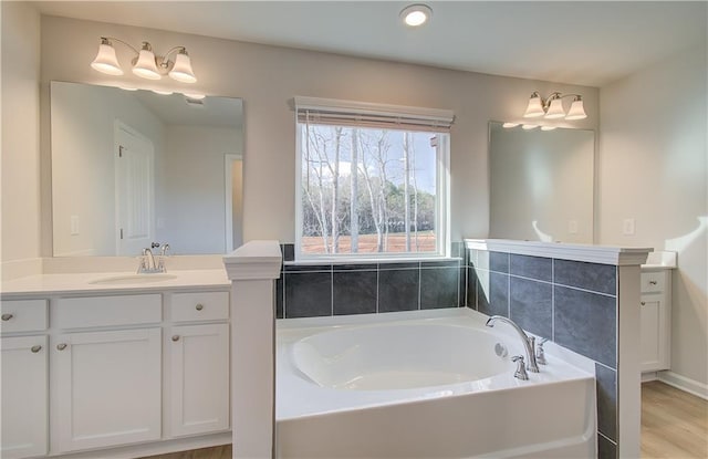 bathroom featuring a tub to relax in and vanity