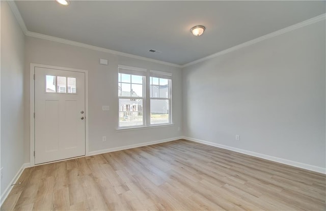 foyer entrance with light wood-type flooring and crown molding