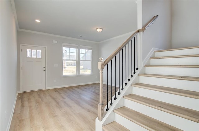 foyer featuring light hardwood / wood-style floors and ornamental molding