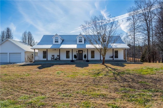 view of front of house with a front yard, a garage, and a porch