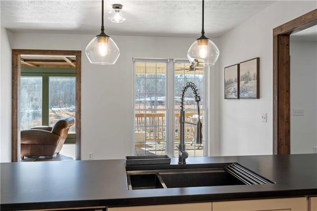 kitchen featuring a textured ceiling and hanging light fixtures