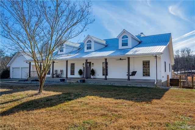 view of front of property with a front yard, covered porch, and a garage