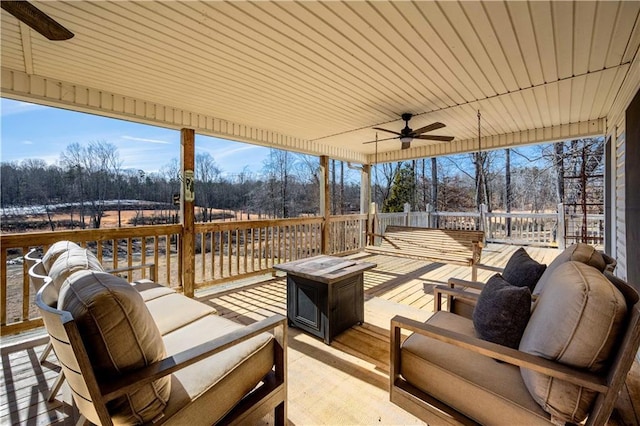 wooden deck featuring ceiling fan