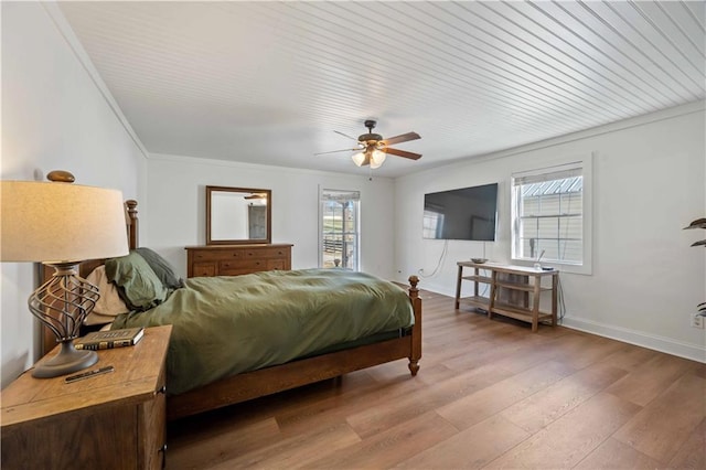 bedroom featuring ceiling fan, light hardwood / wood-style flooring, and crown molding