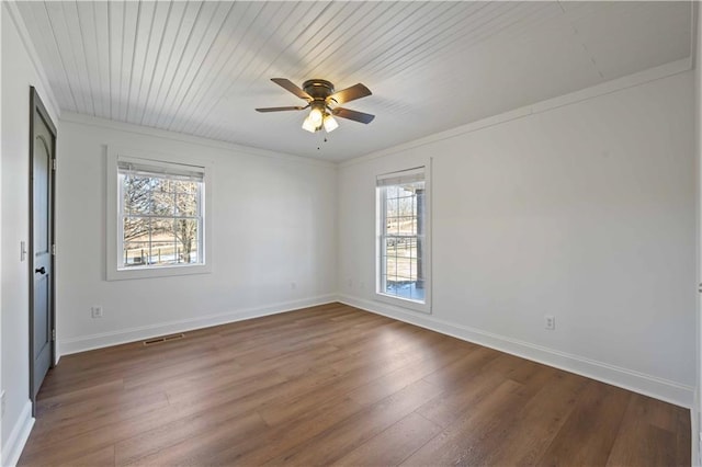 spare room featuring ceiling fan, plenty of natural light, and dark hardwood / wood-style floors