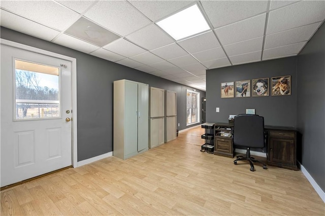 office area featuring a paneled ceiling and light wood-type flooring