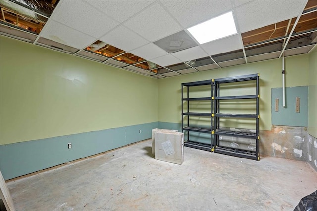 basement with a paneled ceiling