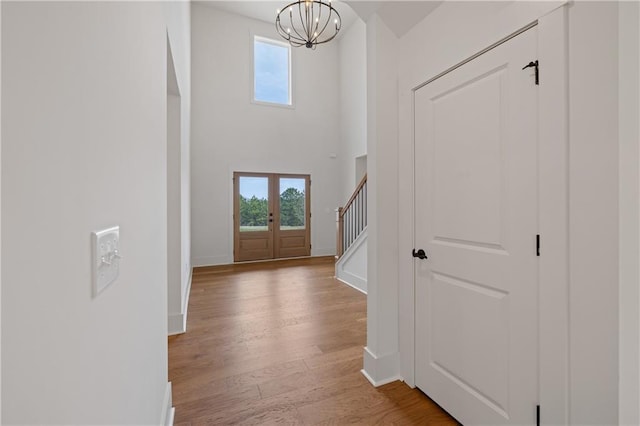 entryway featuring stairway, plenty of natural light, wood finished floors, and french doors