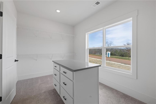 walk in closet featuring visible vents and carpet floors