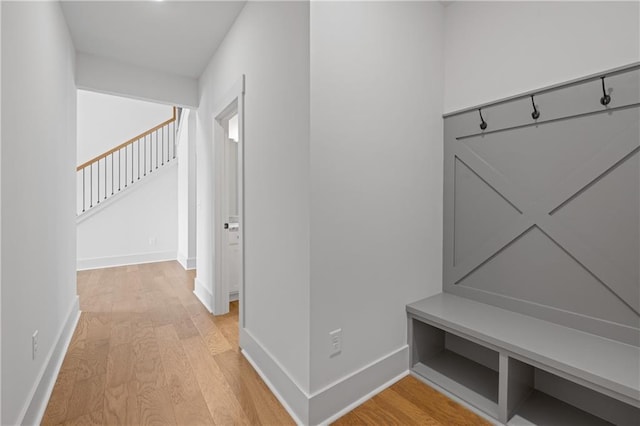 mudroom featuring baseboards and light wood finished floors