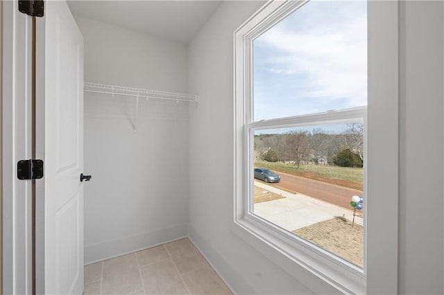 spacious closet featuring light tile patterned floors