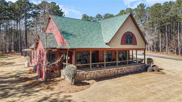 rear view of house featuring a shingled roof, covered porch, driveway, and crawl space