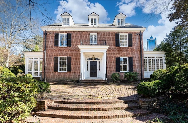 colonial home featuring a balcony