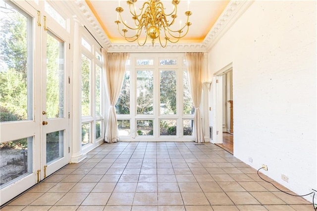 unfurnished sunroom with a notable chandelier