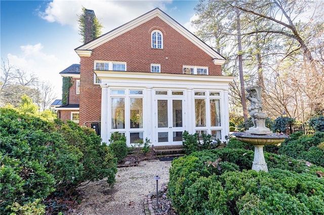 rear view of property with a sunroom