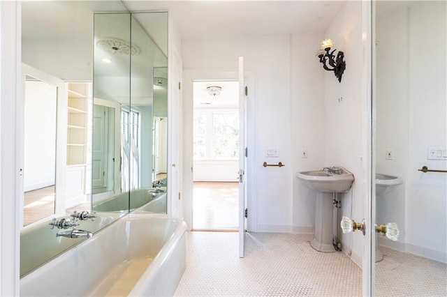 bathroom featuring tile patterned flooring and a bath