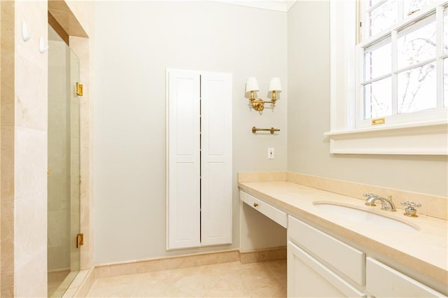 bathroom featuring tile patterned floors, vanity, and a shower with door