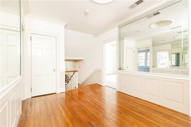 unfurnished room featuring light hardwood / wood-style flooring and ornamental molding