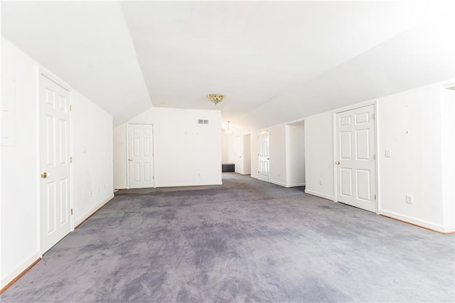 bonus room featuring dark carpet and lofted ceiling