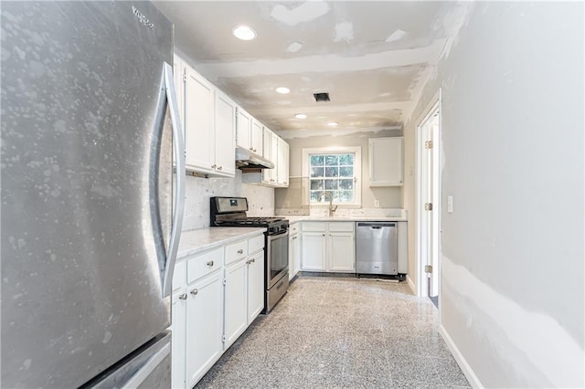 kitchen with white cabinets, sink, appliances with stainless steel finishes, and tasteful backsplash