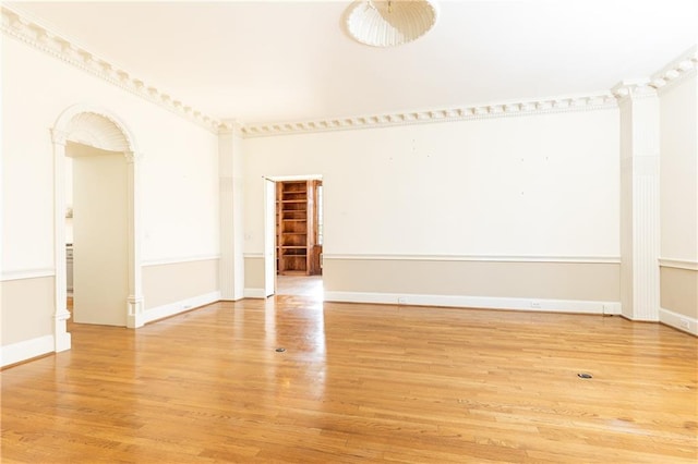 spare room featuring hardwood / wood-style floors and ornamental molding