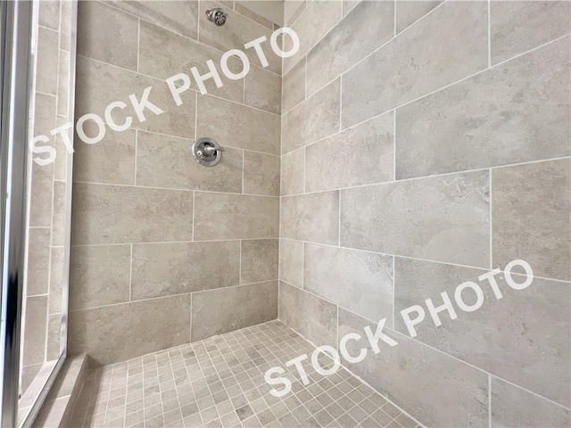 bathroom with tiled shower