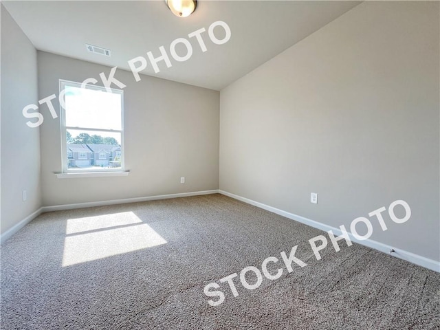 carpeted empty room with visible vents and baseboards