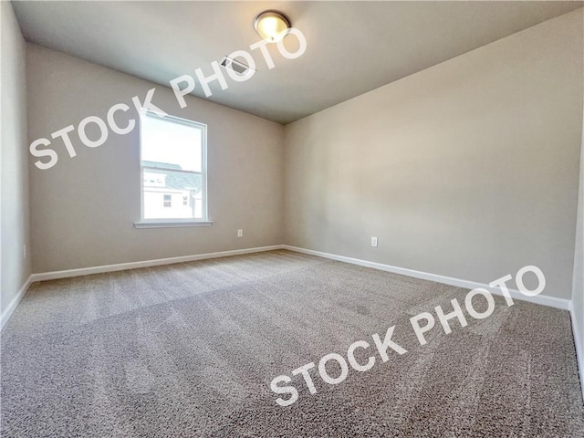 carpeted spare room with baseboards