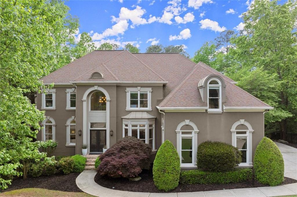 770 Pine Leaf Ct, Alpharetta, GA 30022 - view of front of house with stucco siding and a shingled roof