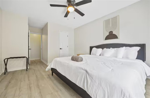 bedroom with ceiling fan and light wood-type flooring