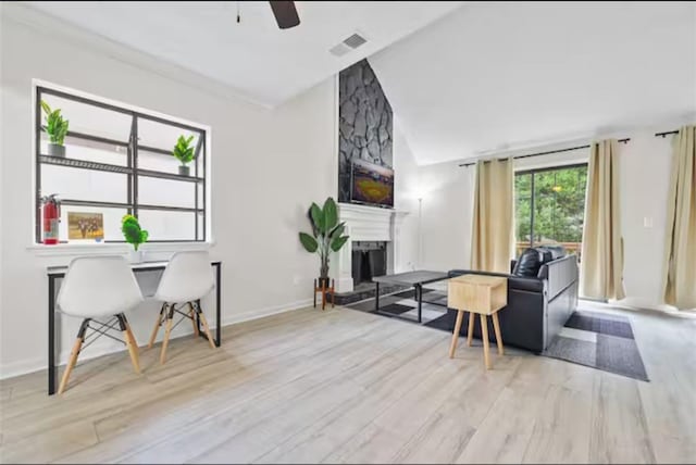 living room with lofted ceiling, light hardwood / wood-style floors, and ceiling fan