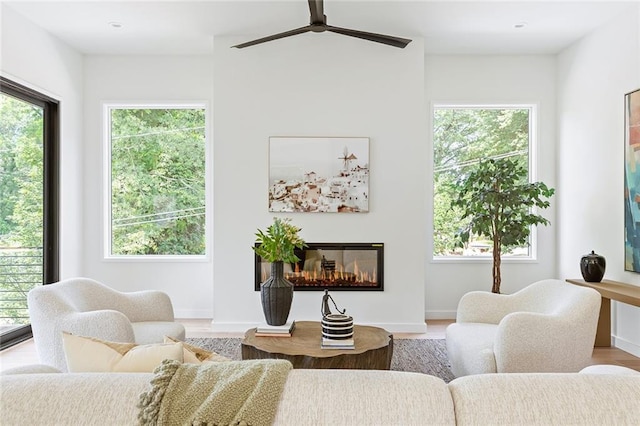 3117 Robinson Ave, Scottdale, GA 30079 - living area featuring a ceiling fan, light wood-style flooring, a glass covered fireplace, baseboards, and recessed lighting
