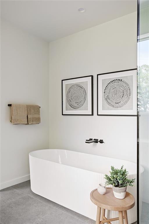3117 Robinson Ave, Scottdale, GA 30079 - bathroom featuring a freestanding bath, tile patterned flooring, and baseboards