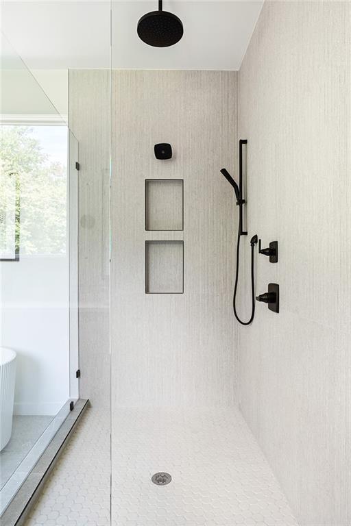 3117 Robinson Ave, Scottdale, GA 30079 - bathroom with a tile shower and a freestanding bath