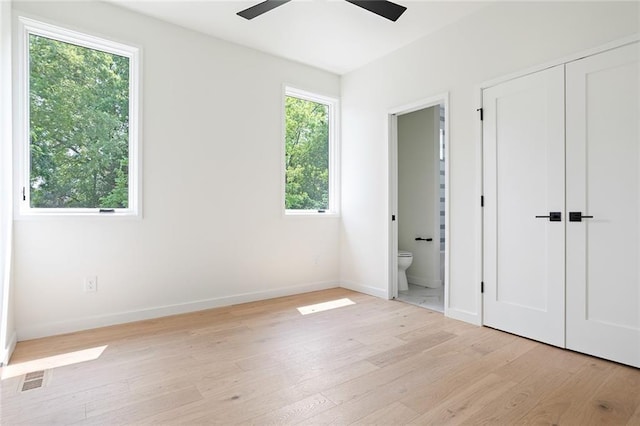 3117 Robinson Ave, Scottdale, GA 30079 - unfurnished bedroom with light wood-style floors, connected bathroom, and baseboards