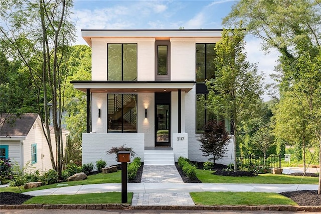 3117 Robinson Ave, Scottdale, GA 30079 - contemporary home with brick siding, a porch, and a front yard