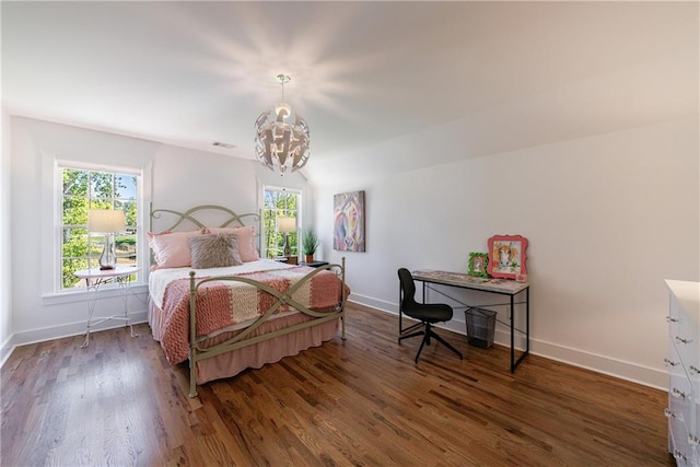 bedroom with an inviting chandelier, wood finished floors, baseboards, and multiple windows