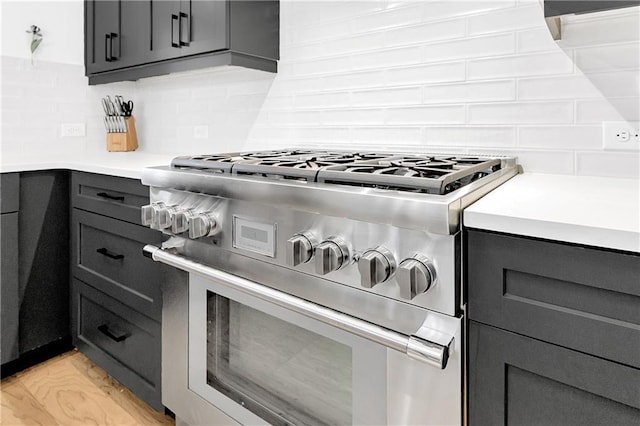 10862 Serenbe Ln, Chattahoochee Hills, GA 30268 - kitchen featuring high end stainless steel range oven, backsplash, light countertops, and gray cabinets
