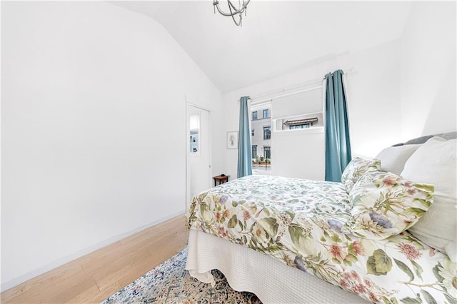 10862 Serenbe Ln, Chattahoochee Hills, GA 30268 - bedroom featuring wood finished floors and vaulted ceiling